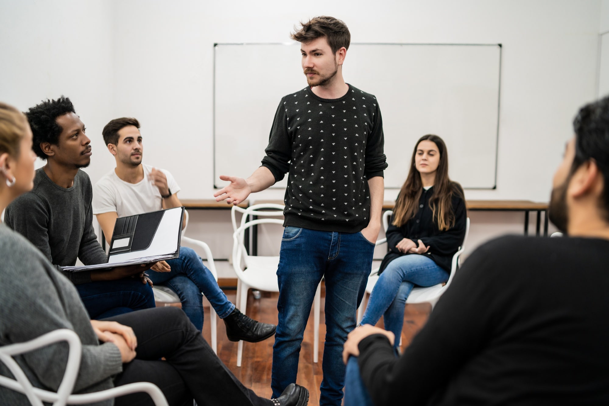 A professional facilitator leading a group discussion and guiding participants during a team session.